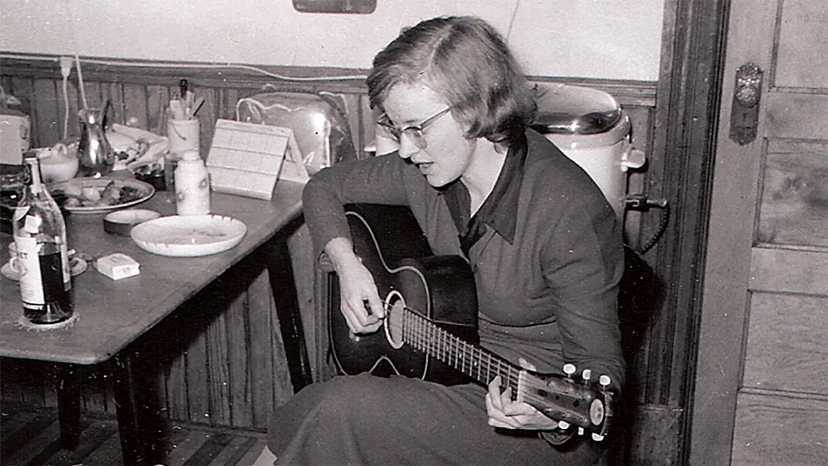 Connie Converse playing her acoustic guitar