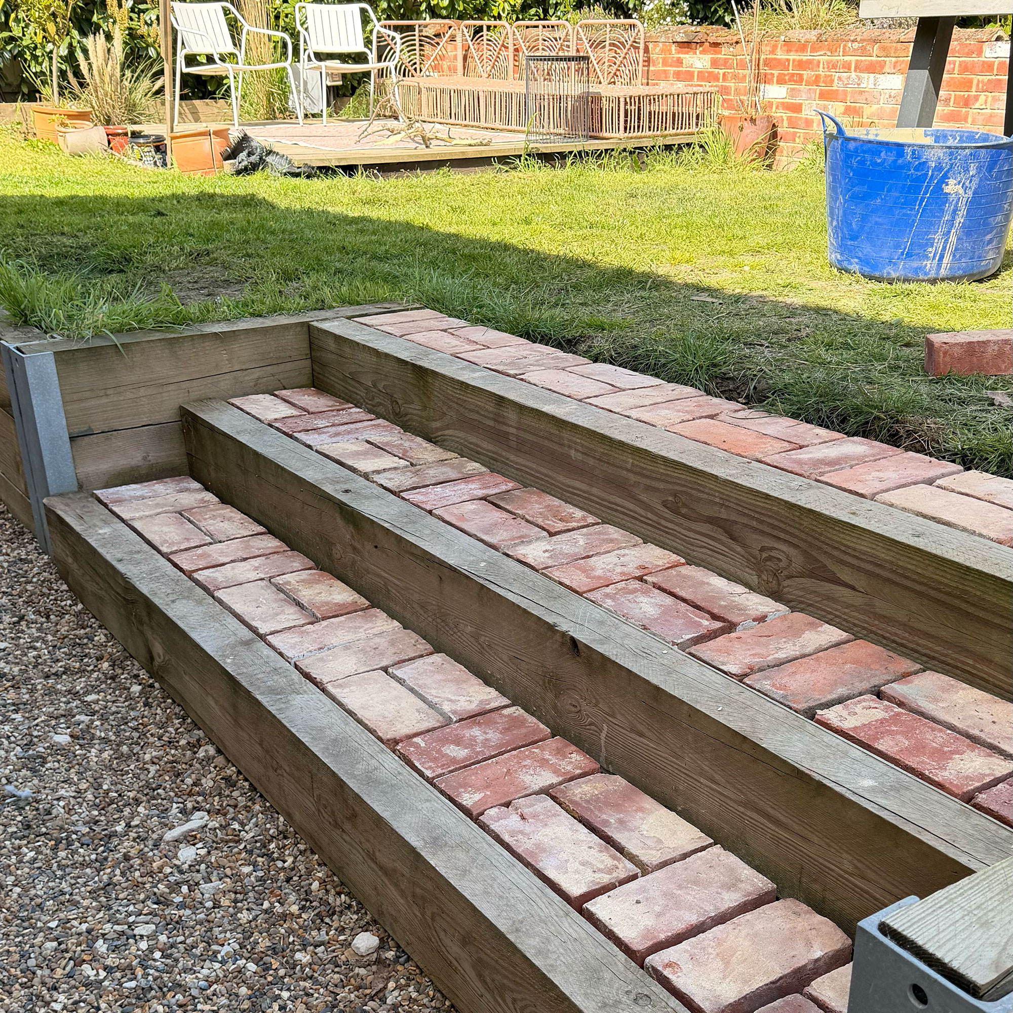 Red brick and wooden steps in garden
