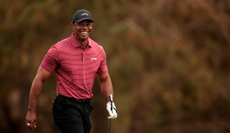 Tiger Woods walks off the green smiling