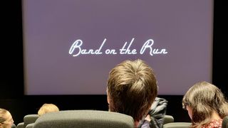 Band on the Run title at Dolby, Soho Square, with people sitting in front of the screen