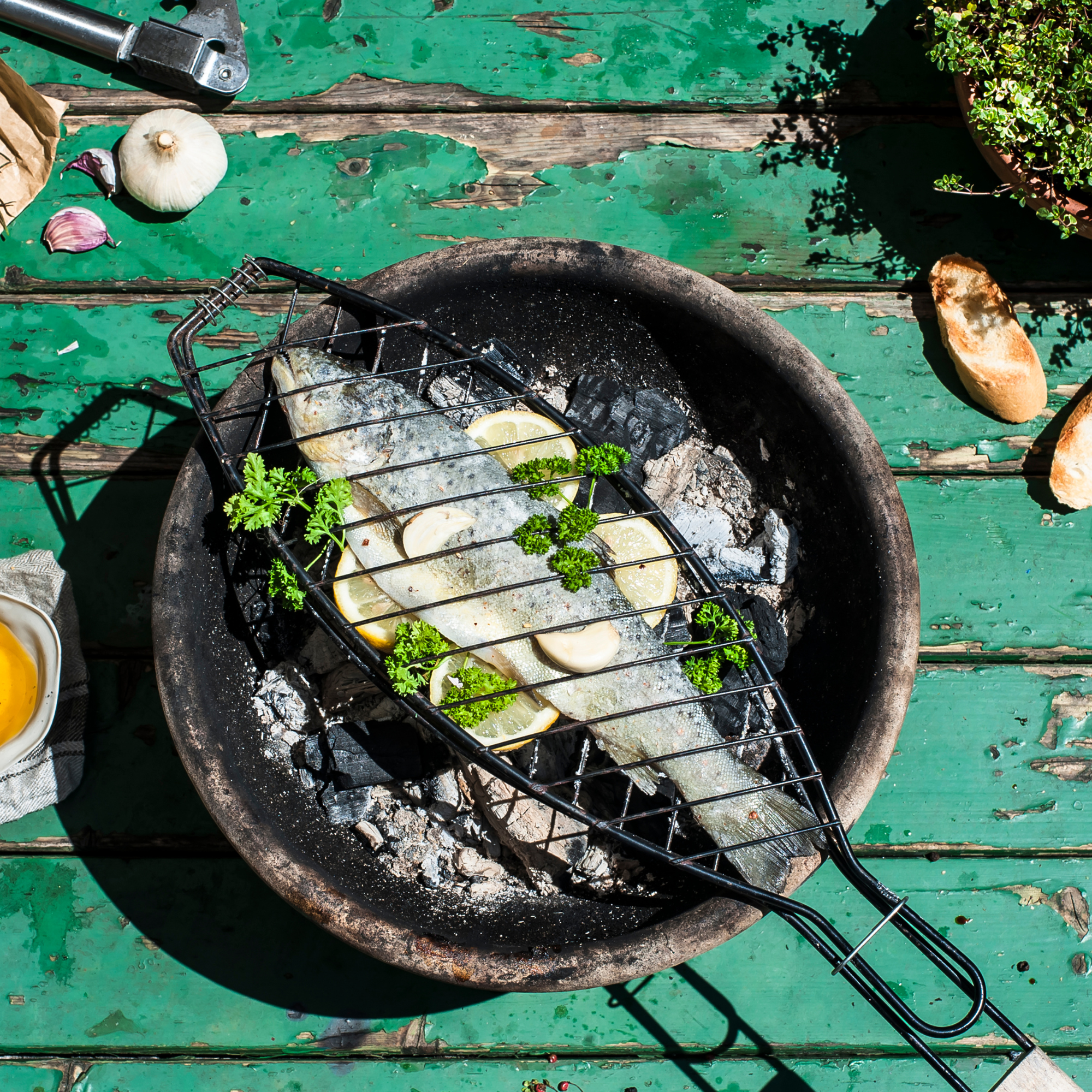 Fish cooking on barbecue grill.
