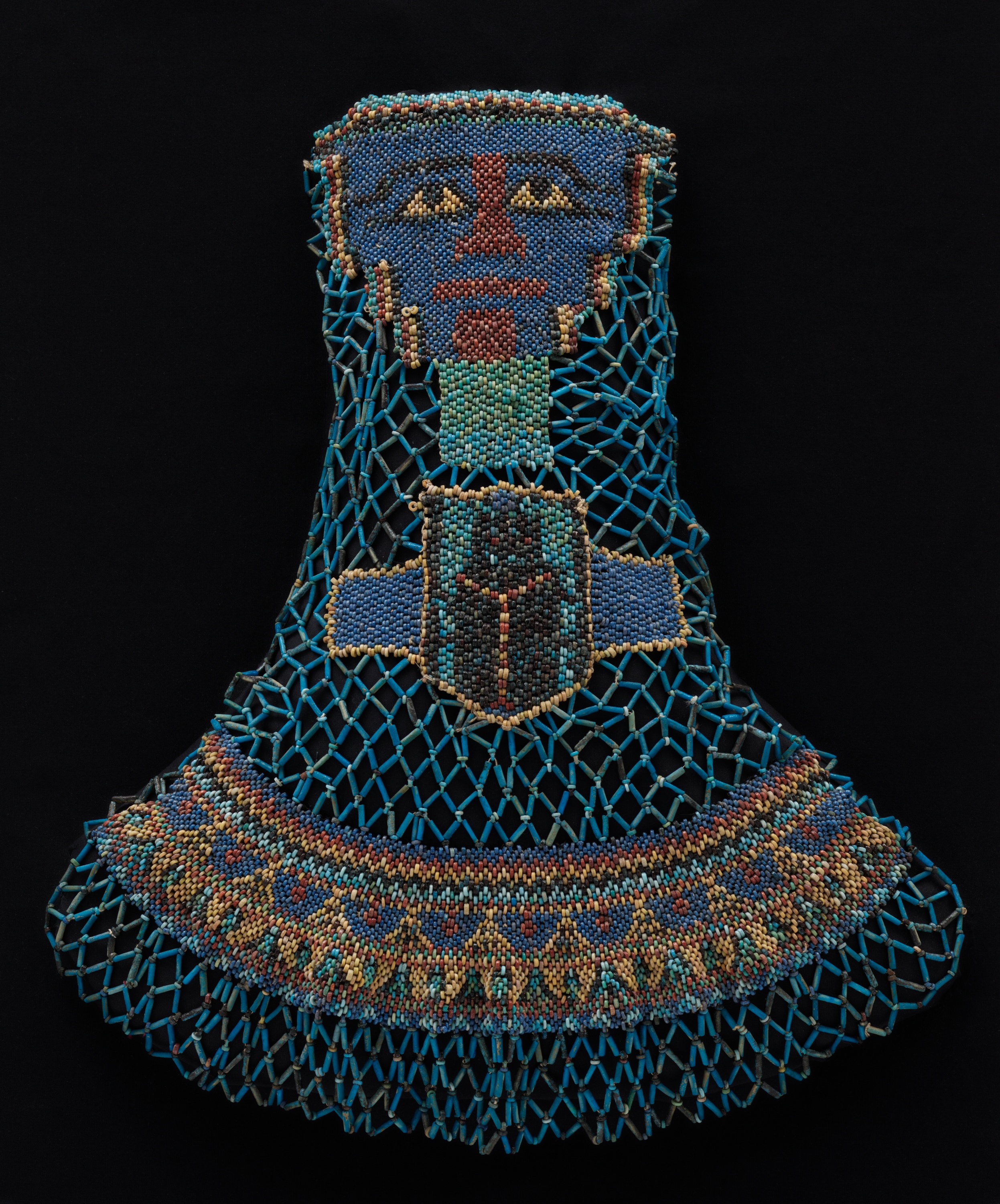 a beaded funeral shroud from ancient Egypt that depicts a person's face and a large scarab beetle