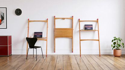 A white room with three sit-stand bamboo folding desks from Leandesk, a red storage cabinet, a potted plant, and a black chair