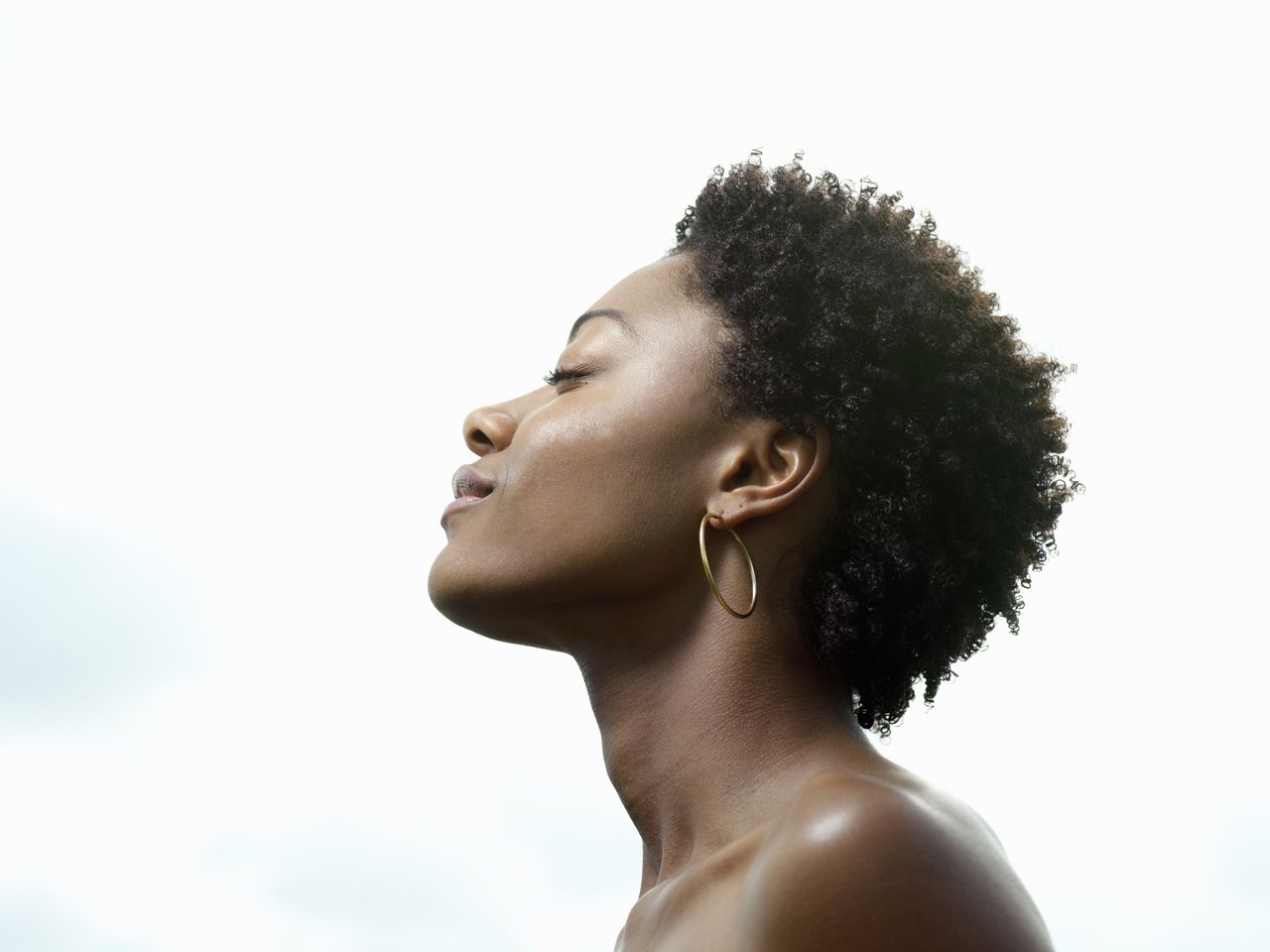 Menstrual cycle phases: Young woman, eyes closed, low angle view, profile