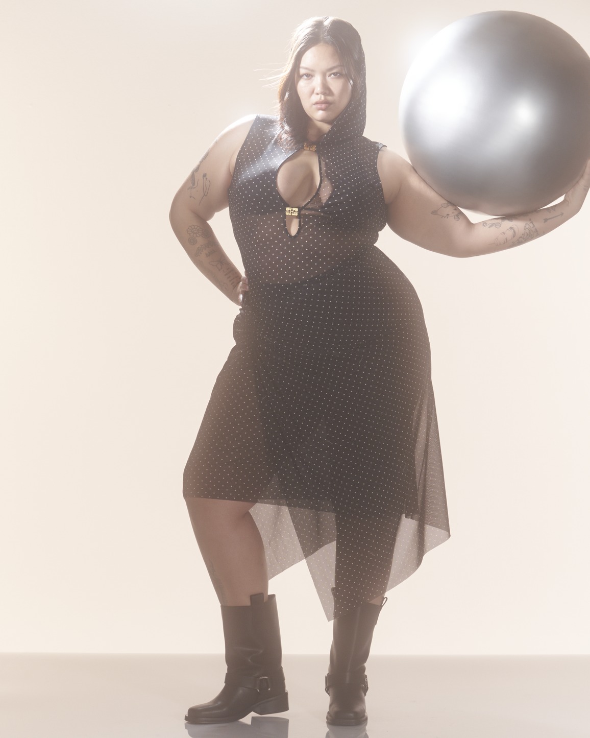 Ganni x Paloma Elsesser Campagin Photography: model holding a silver ball