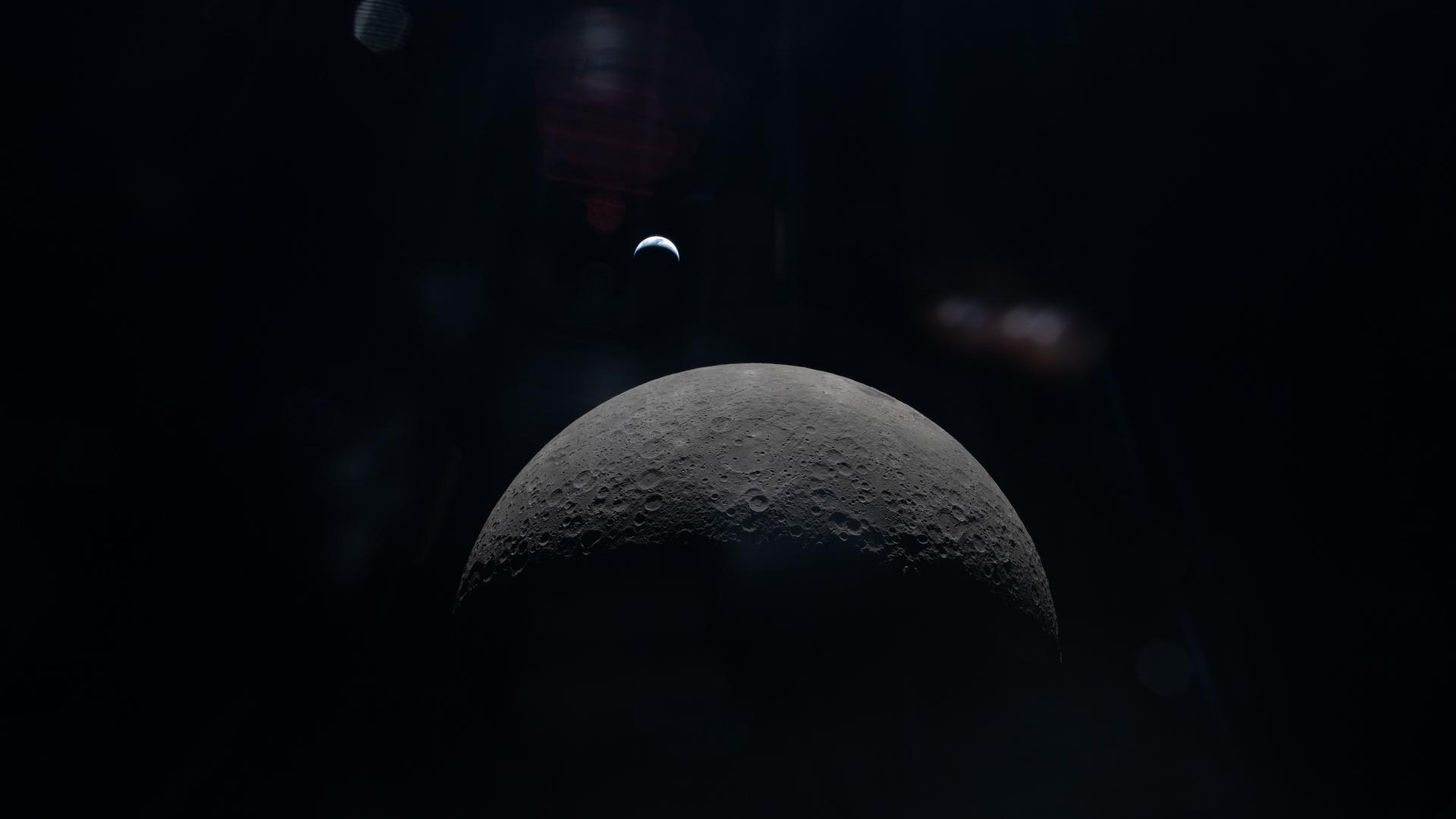 A view of the moon with the Earth in the background