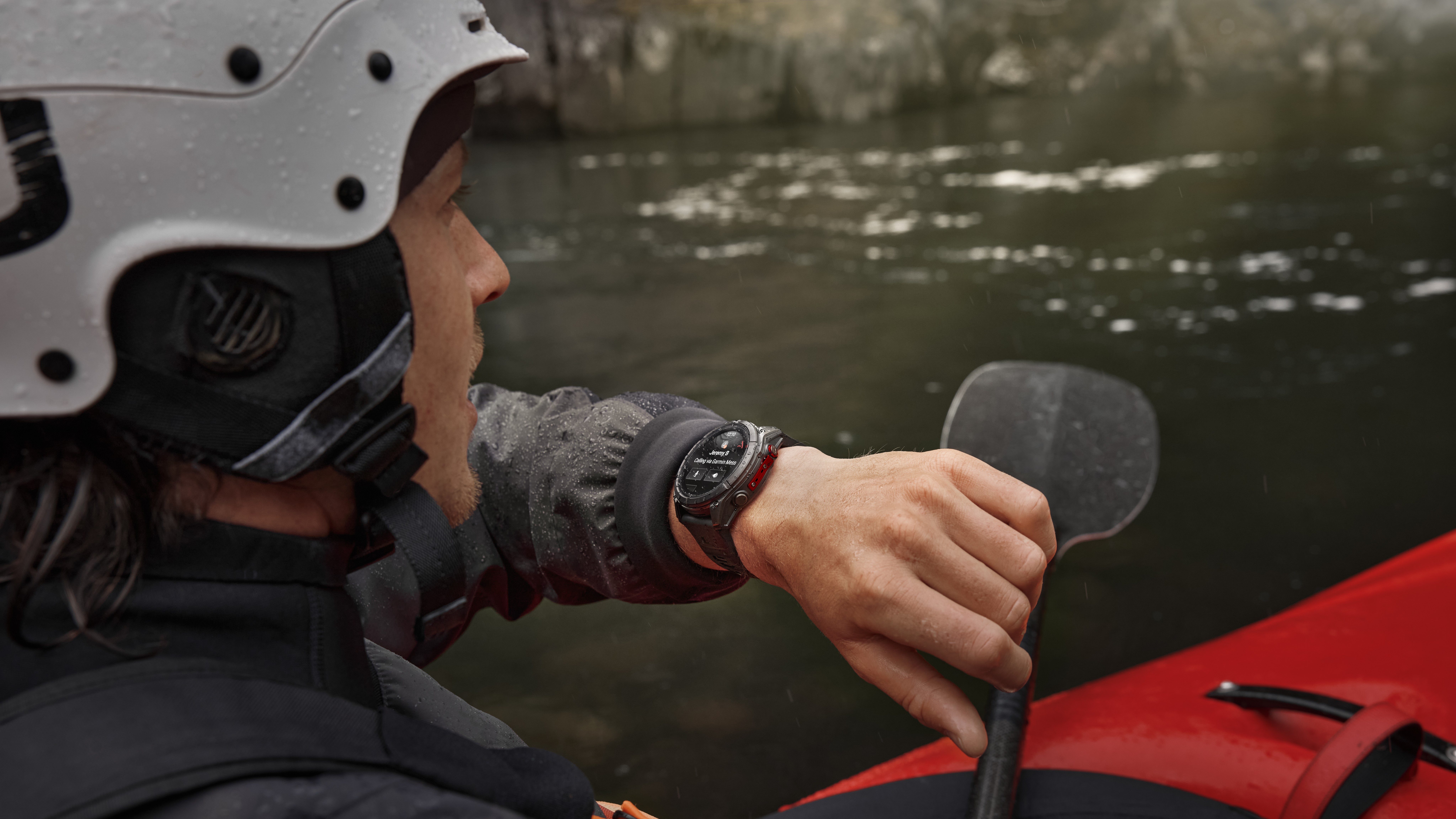 A photo of a woman kayaking while wearing a Garmin Fenix 8 Pro, using it to call someone using LTE cellular data.