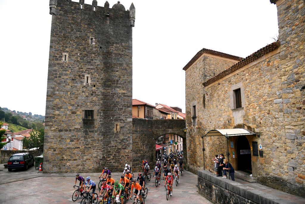 ALTU DEL GAMONITEIRU SPAIN SEPTEMBER 02 A general view of Romain Bardet of France and Team DSM polka dot mountain jersey Primoz Roglic of Slovenia and Team Jumbo Visma red leader jersey Fabio Jakobsen of Netherlands and Team Deceuninck QuickStep green points jersey and the peloton compete in Salas village at start during the 76th Tour of Spain 2021 Stage 18 a 1626km stage from Salas to Altu dEl Gamoniteiru 1770m lavuelta LaVuelta21 on September 02 2021 in Altu dEl Gamoniteiru Spain Photo by Tim de WaeleGetty Images