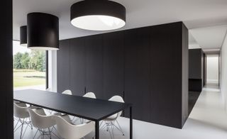 Black dining table with white chairs