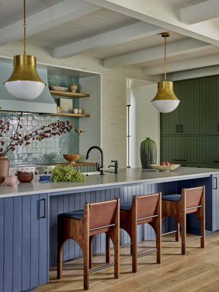 colorful blue kitchen with blue cabinets and light blue tiles