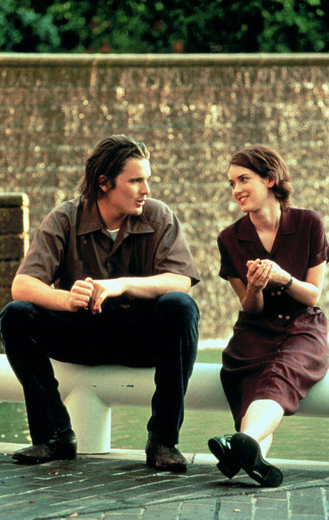 Ethan Hawke and Winona Ryder have a conversation sitting on the street by water in 'Reality Bites'