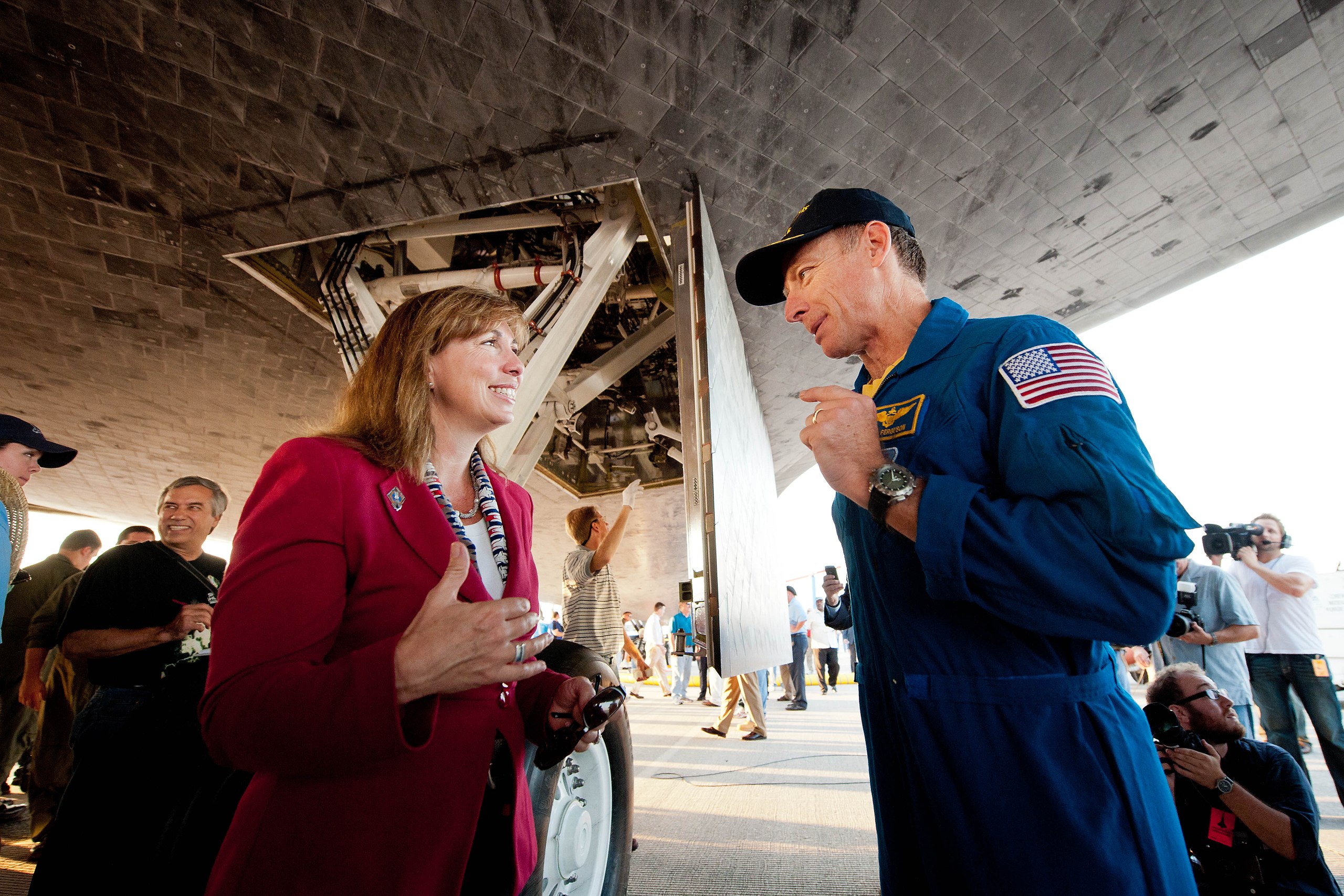 NASA Deputy Administrator Lori Garver and Commander Chris Ferguson talk underneath the space shuttle Atlantis shortly after Ferguson and the rest of the STS-135 crew landed at NASA's Kennedy Space Center Shuttle Landing Facility (SLF) in July 2011.