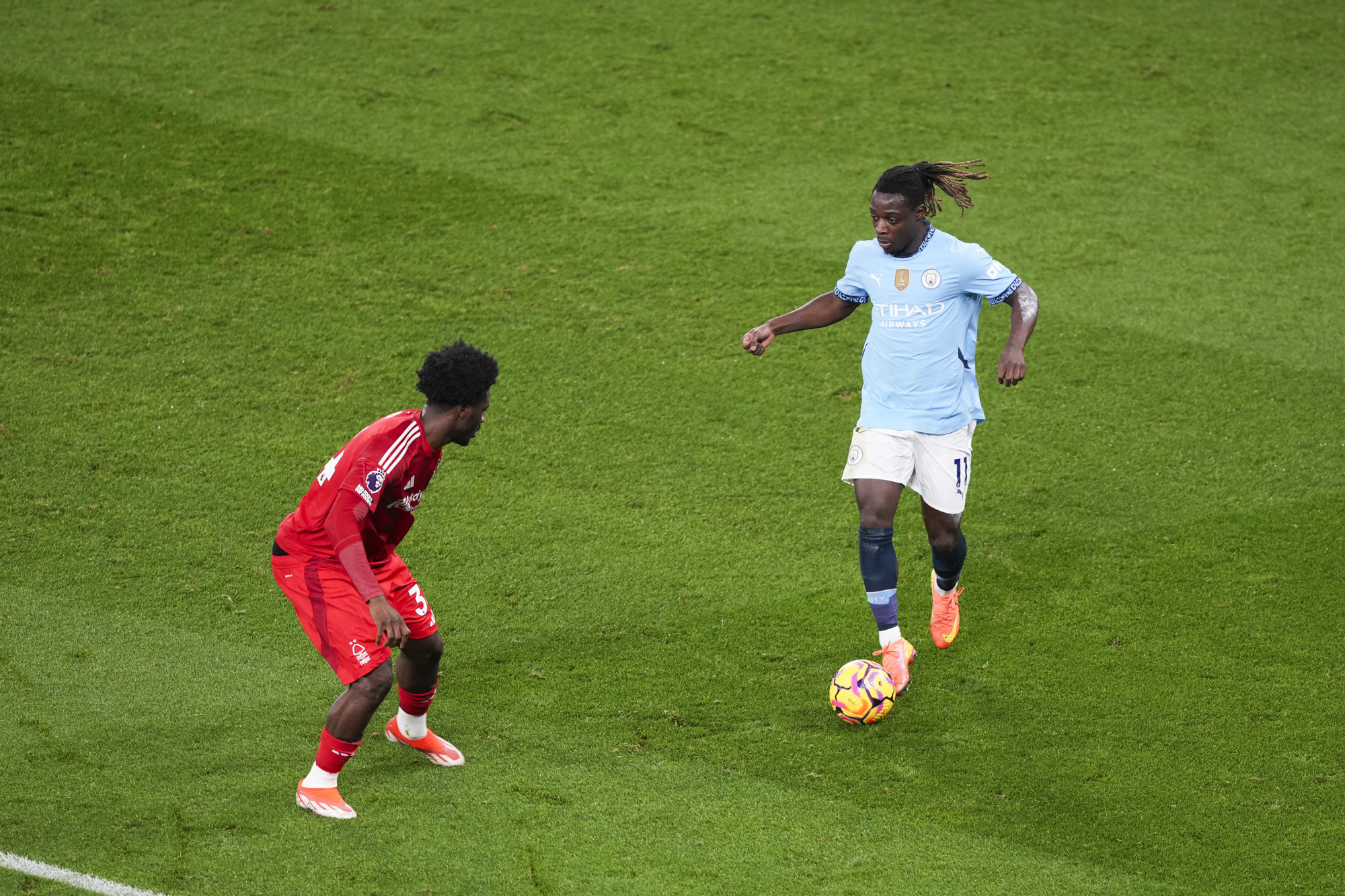 Manchester City player Jeremy Doke dribbling the ball, defended by Ola Aina