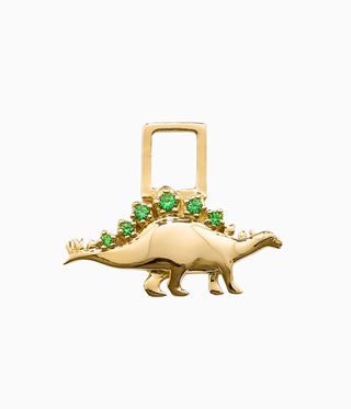 Gold dinosaur with emeralds on its spikes