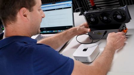 A screenshot of a YouTube video by Alex Ziskind, where they use tiny corp's TinyGPU app to use an Nvidia RTX 50-series graphics card with an Apple Mac mini