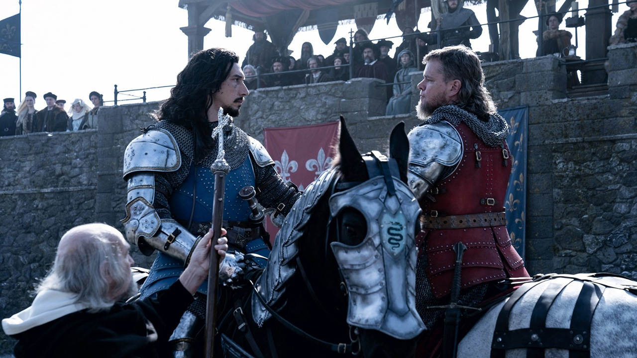 A still from The Last Duel featuring Adam Driver and Matt Damon's characters dressed in armour and squaring off on horses.