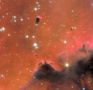 The Soul Nebula, located 7,000 light-years from Earth, is infused with a red glow in this image from the Hubble Space Telescope.