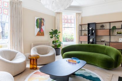 Green velvet curved sofa in a living room