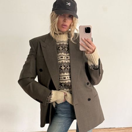 Elsa Hosk takes a mirror selfie wearing blue jeans with a mole-coloured blazer and matching heels.