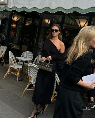 Anne Laure Mais wears a black dress and black heels