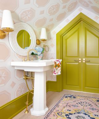 colors that go with light pink, pink and chartreuse bathroom, pale pink wallpaper, chartreuse door and woodwork, vintage rug