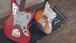 Two Fender Jaguar guitars lying on hard case
