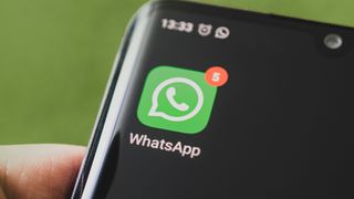 Icon of the WhatsApp, app on the screen of a black smartphone
