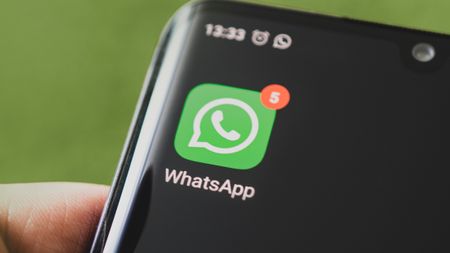 Icon of the WhatsApp, app on the screen of a black smartphone