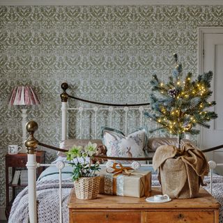 Bedroom with wrought iron bed and festive decorations