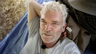 Phillip Schofield sitting on a deserted beach for Cast Away