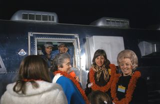 Wives and children of the Apollo 12 crew greet the returning astronauts in their Mobile Quarantine Facility. The crew quarantine procedures were used for Apollo 11, 12 and 14, then deemed unnecessary.