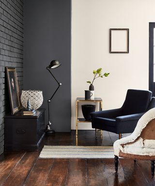 Living room painted in dark gray and beige with dark wooden floors