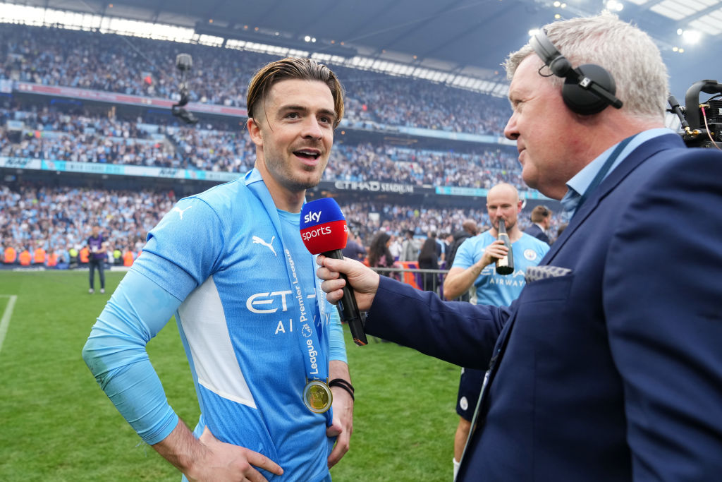 Jack Grealish of Manchester City is interviewed by Geoff Shreeves of Sky Sports after their side finished the season as Premier League champions during the Premier League match between Manchester City and Aston Villa at Etihad Stadium on May 22, 2022 in Manchester, England.