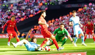 Mohamed Salah, centre, is kept at bay by Manchester City’s Nathan Ake, left, and goalkeeper Zack Steffen