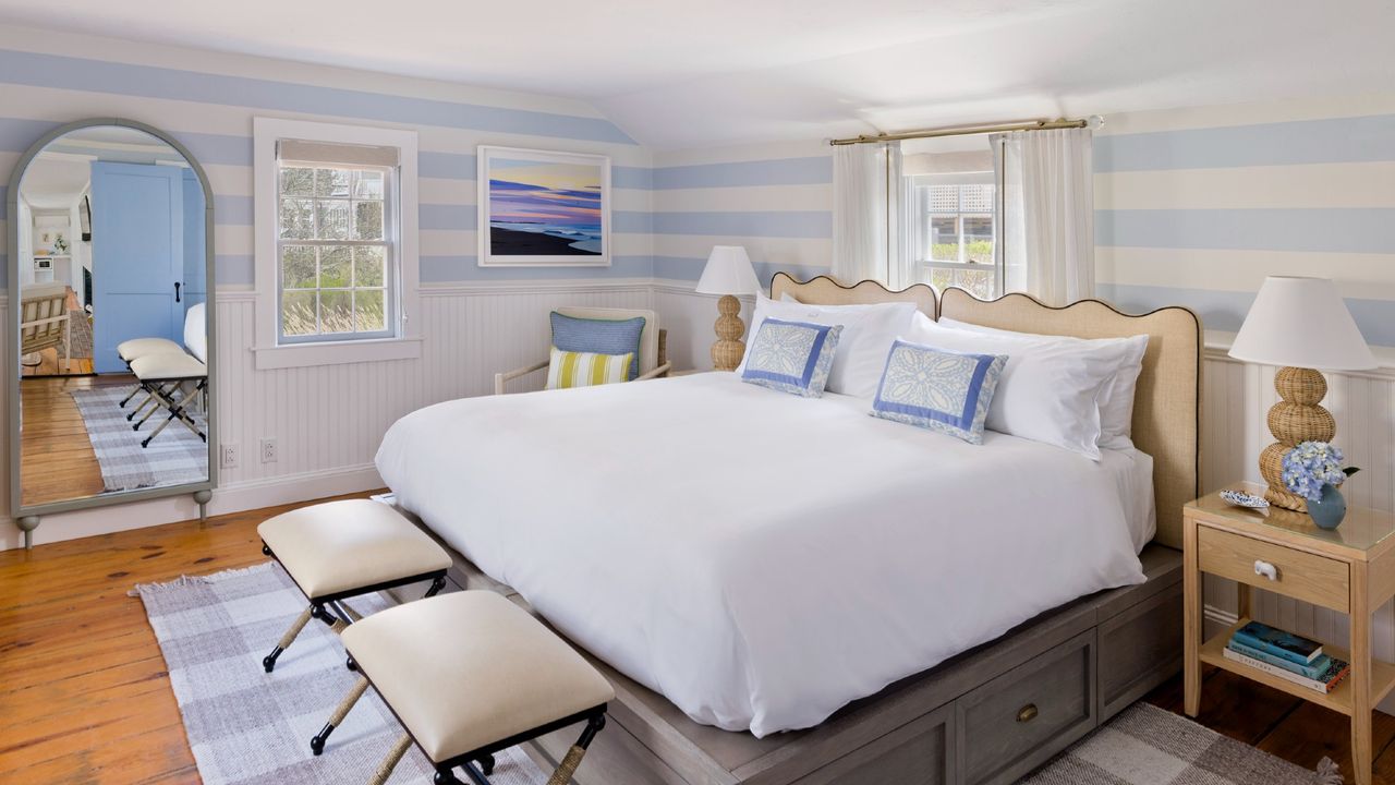 A room at the White Elephant Nantucket with a white bed and blue accents