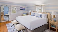 A room at the White Elephant Nantucket with a white bed and blue accents