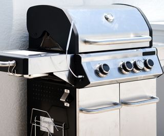 large stainless-steel gas grill on a patio