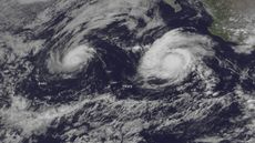 NOAA's GOES East satellite captured this visible image of Hurricanes Irwin (left) and Hilary (right) spinning in the east Pacific Ocean on July 25, 2017.