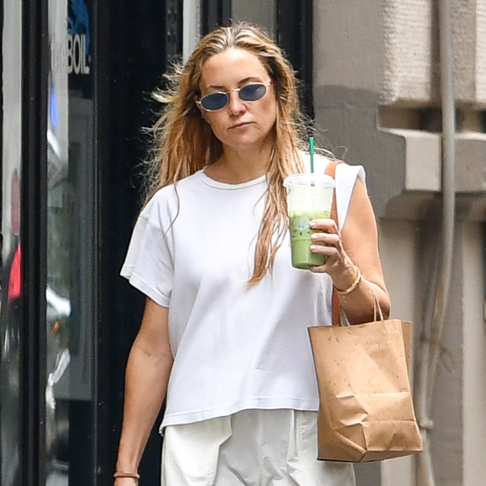 Kate Hudson wearing a white T-shirt, balloon cargo pants, and Birkenstock Boston clogs