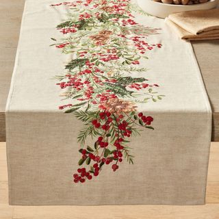 Holly Berry Embroidered Cotton/Linen Table Runner on a table.