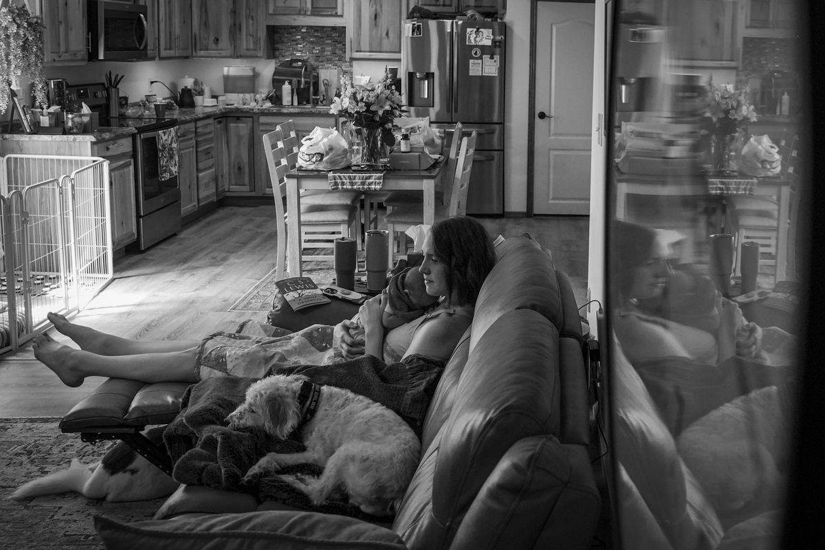 While waiting to attend the viewing of the body of her recently deceased husband, Shay Wright Martin relaxes with her daughter