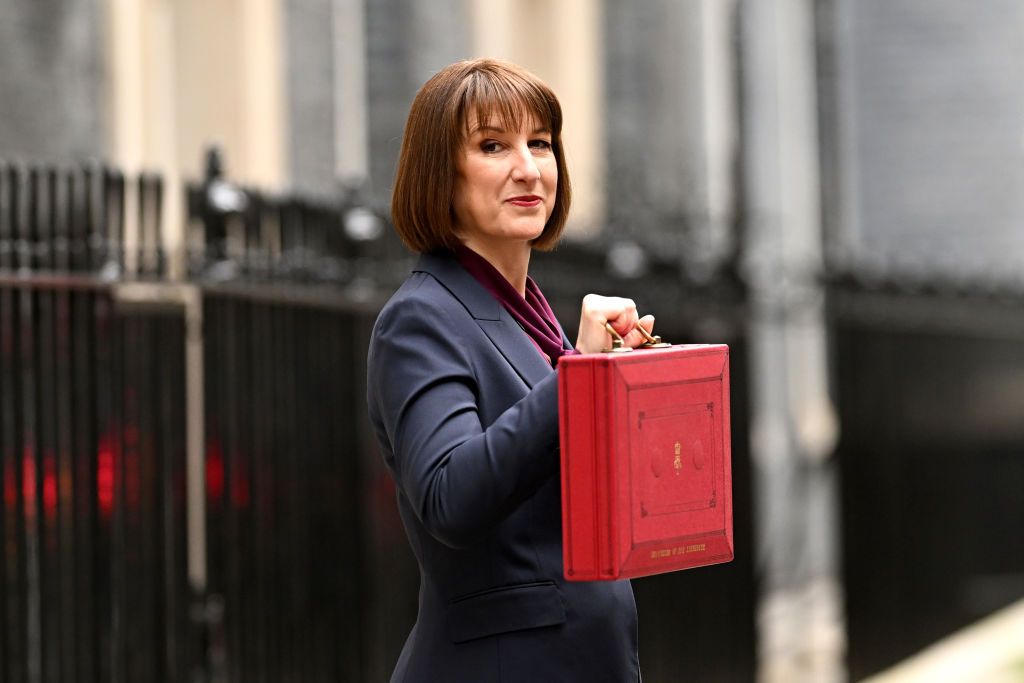 Chancellor Rachel Reeves standing outside 11 Downing Street with the red Budget box