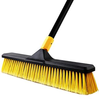 A yellow and black outdoor brush