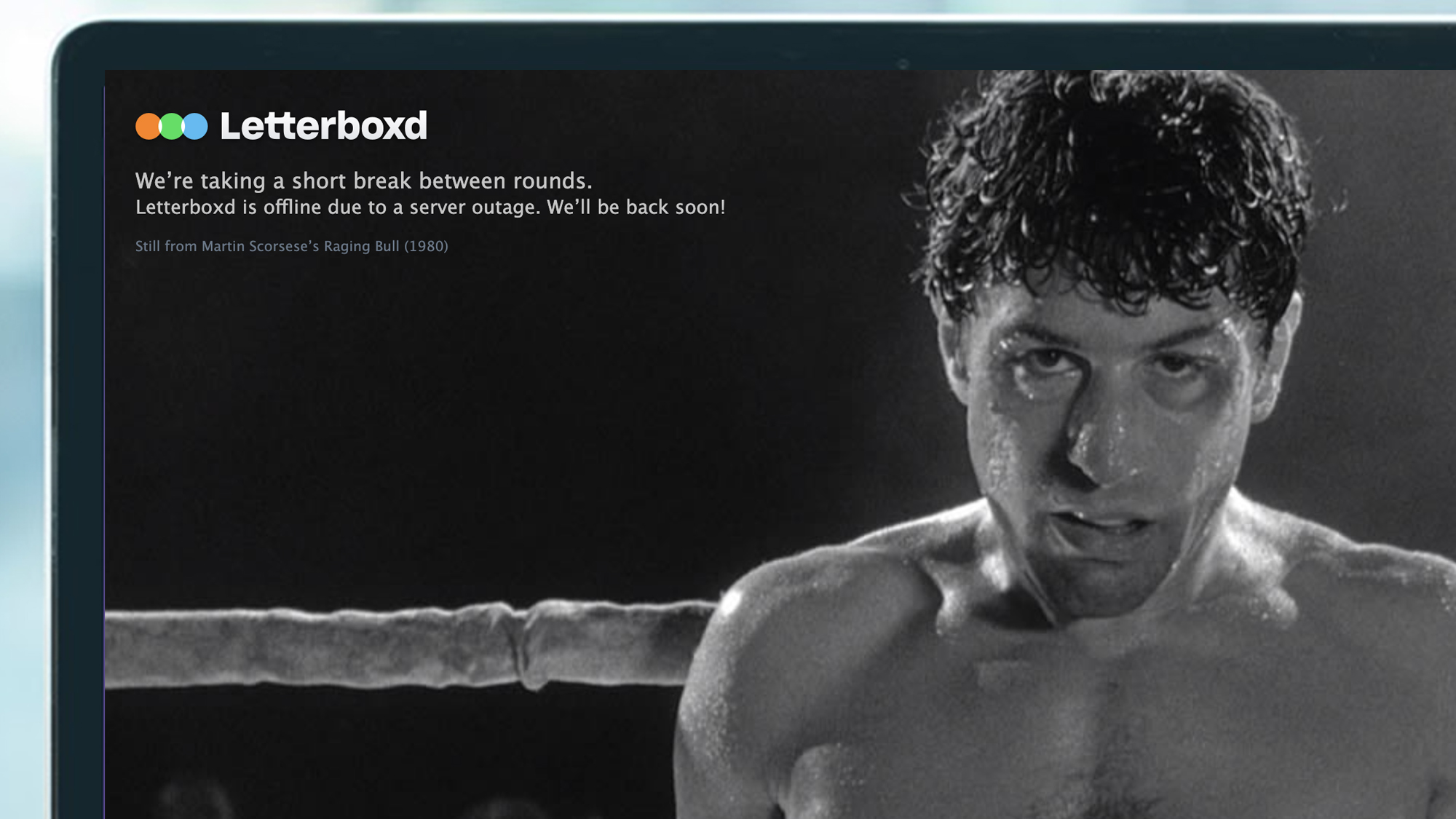 A laptop screen showing a still from Raging Bull for a Letterboxd outage
