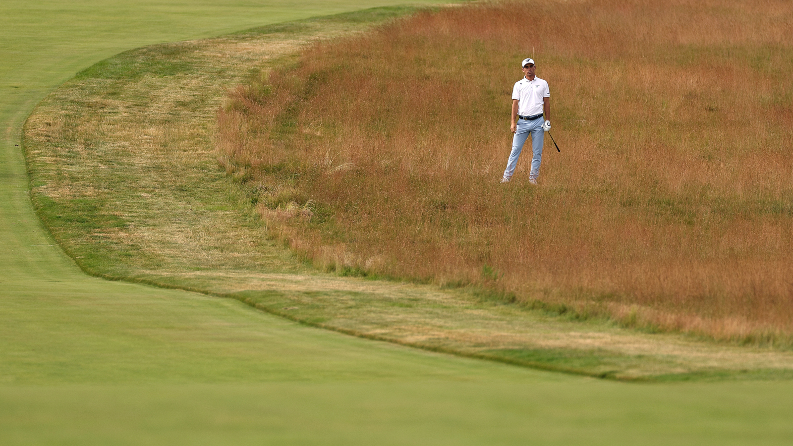 Joaquin Niemann waits to play a shot