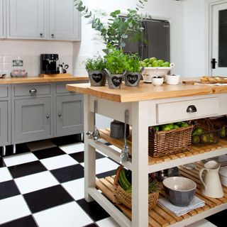 kitchen island with wooden top and undercounter storage shelves