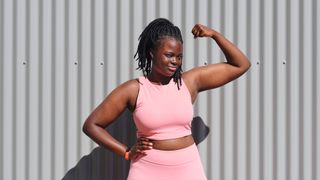 Does protein powder make you gain weight? Image shows woman flexing arm muscle