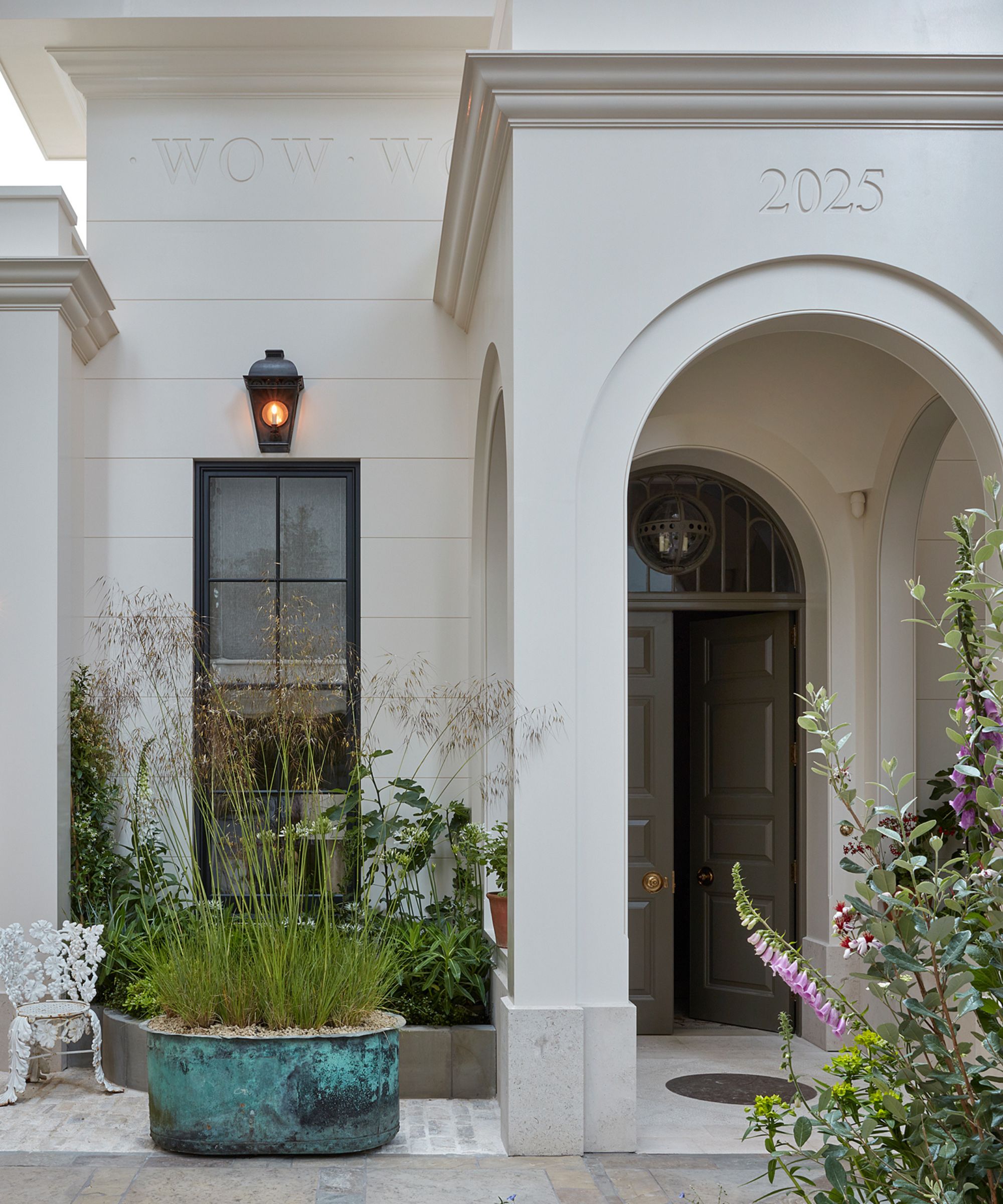 The exterior of a house with large planters