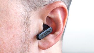 Close-up view of Urbanista Phoenix earbud in ear.