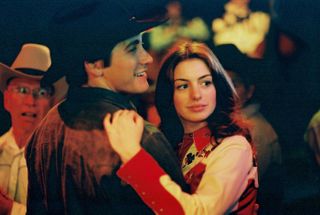 Jake Gyllenhaal and Anne Hathaway wearing western wear on a dance floor in 'Brokeback Mountain'